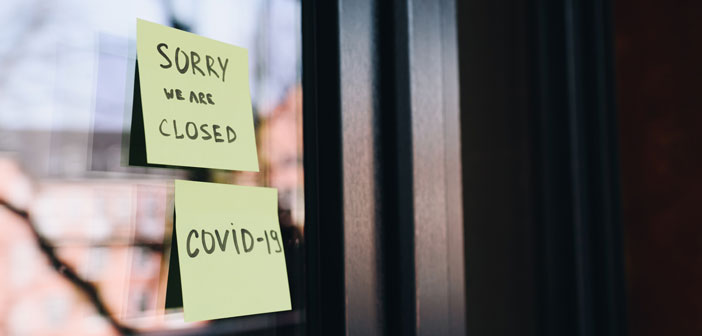 sticky note on a door "Sorry we are closed. COVID-19"